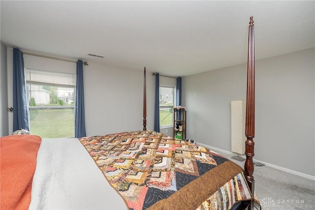 bedroom with visible vents, baseboards, and carpet flooring