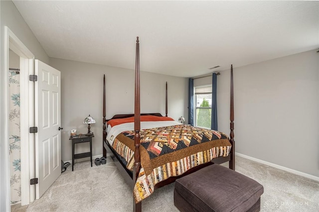 bedroom featuring light carpet and baseboards