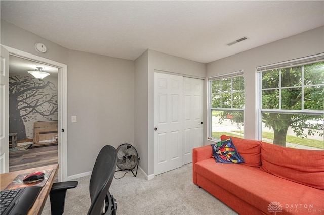 office with baseboards, visible vents, and carpet flooring