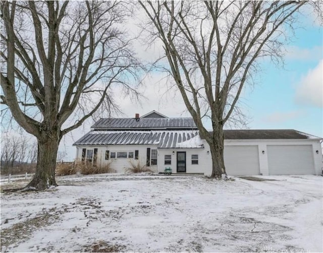 view of front facade featuring metal roof and an attached garage