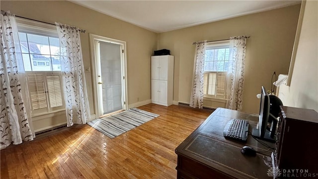 office space with wood finished floors and baseboards