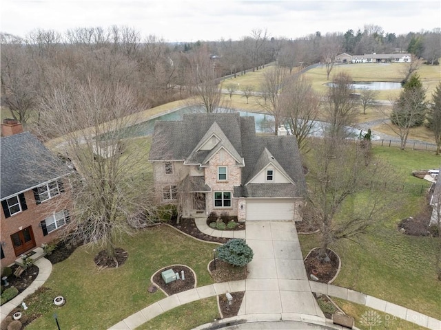 birds eye view of property with a water view