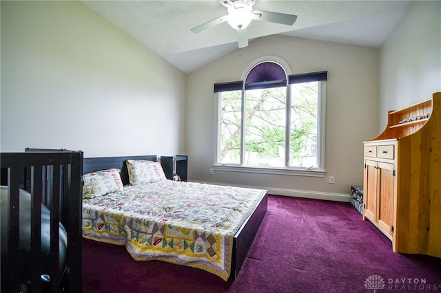 bedroom featuring lofted ceiling, baseboards, dark colored carpet, and a ceiling fan