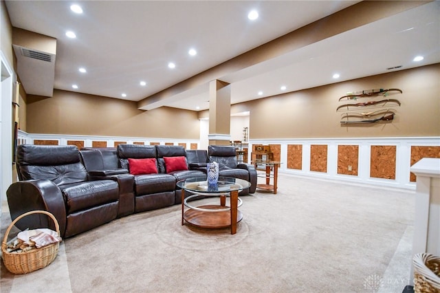 carpeted living area with a wainscoted wall, recessed lighting, visible vents, and a decorative wall