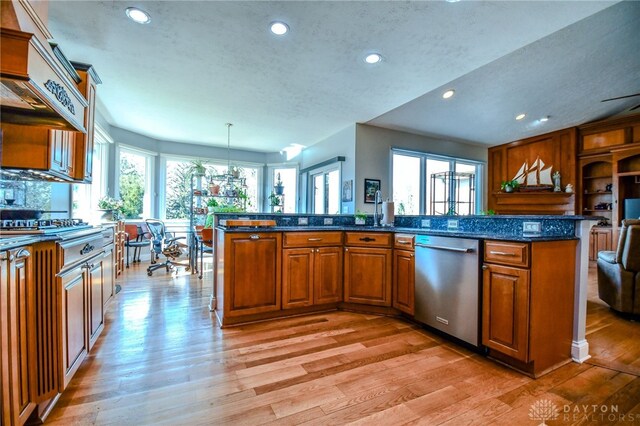 kitchen with dishwasher, light wood-style flooring, brown cabinetry, and a wealth of natural light