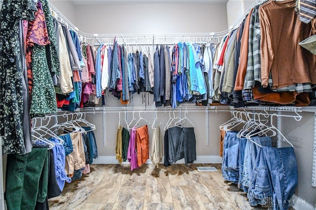 spacious closet with wood finished floors and visible vents