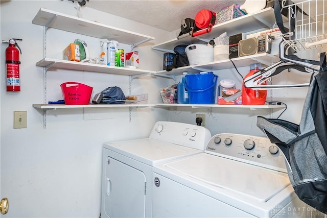 washroom featuring laundry area, independent washer and dryer, and a textured ceiling