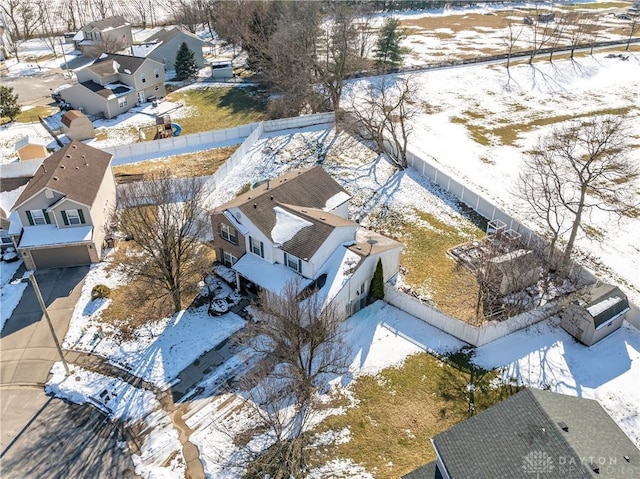 snowy aerial view with a residential view