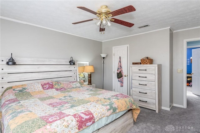 carpeted bedroom featuring visible vents, ornamental molding, a ceiling fan, a textured ceiling, and baseboards