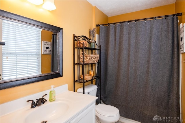 bathroom with a shower with curtain, vanity, and toilet