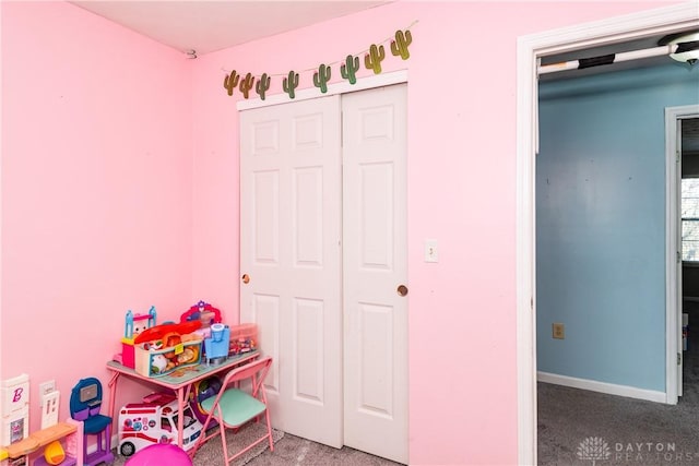 playroom featuring carpet floors and baseboards