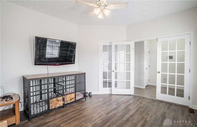 living area featuring a textured ceiling, french doors, wood finished floors, and a ceiling fan