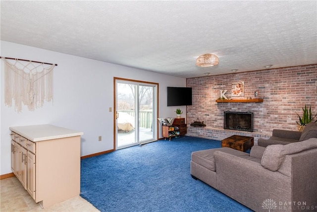 living area with a brick fireplace, a textured ceiling, and baseboards