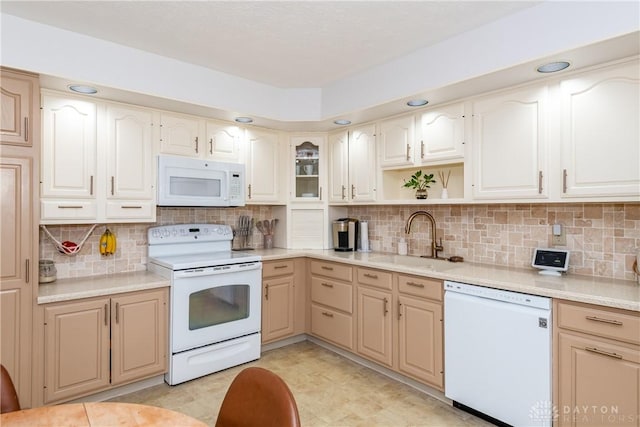 kitchen featuring white appliances, a sink, light countertops, decorative backsplash, and open shelves