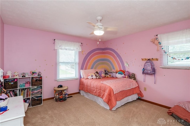 bedroom with baseboards, a ceiling fan, and light colored carpet