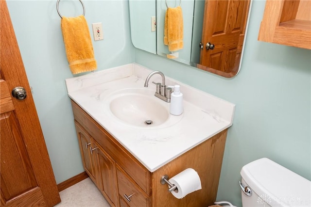 bathroom featuring toilet and vanity