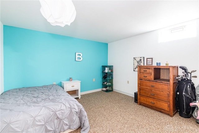 bedroom featuring light carpet and baseboards