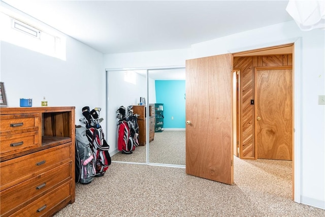 bedroom featuring carpet, a closet, and baseboards