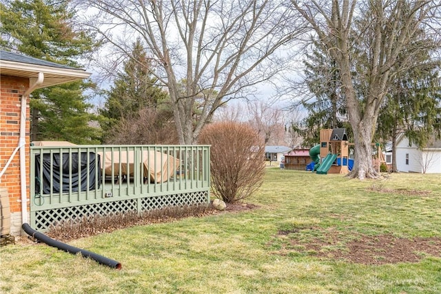 view of yard with a playground and a deck