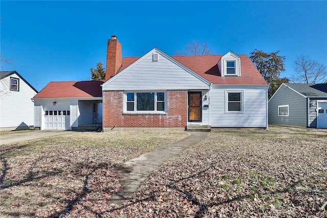 view of front of house featuring concrete driveway, brick siding, a chimney, and an attached garage