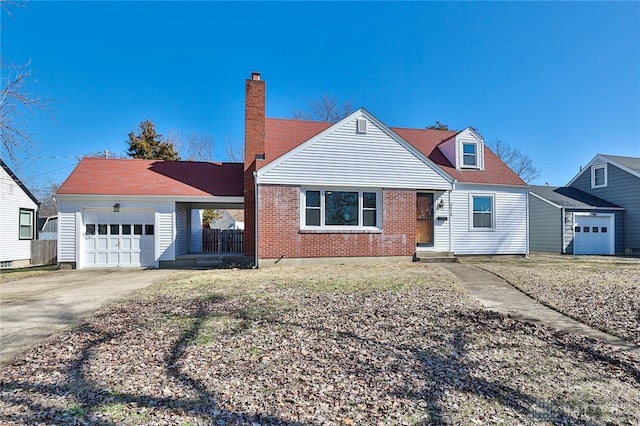 view of front of property featuring a garage, driveway, a chimney, and brick siding