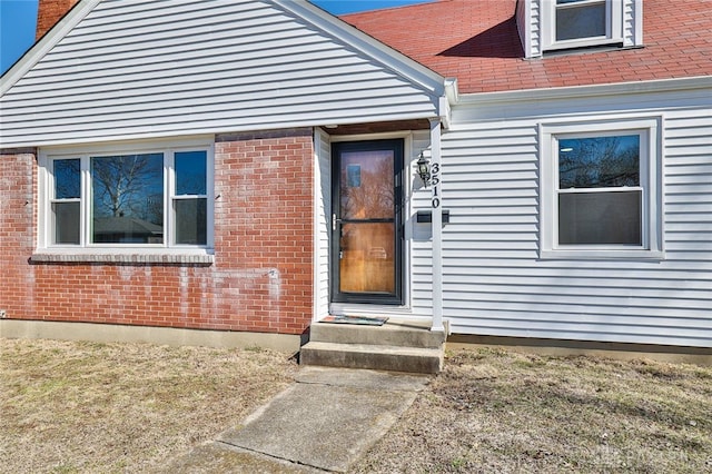 property entrance with brick siding