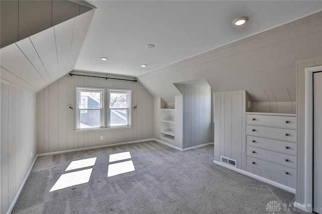 bonus room featuring carpet floors, baseboards, visible vents, and vaulted ceiling