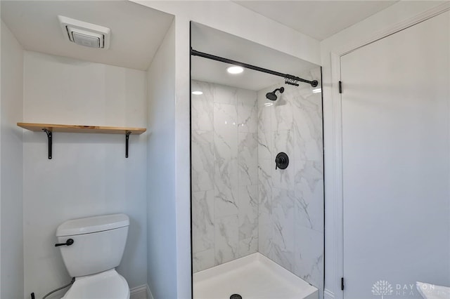 bathroom with toilet and a shower stall