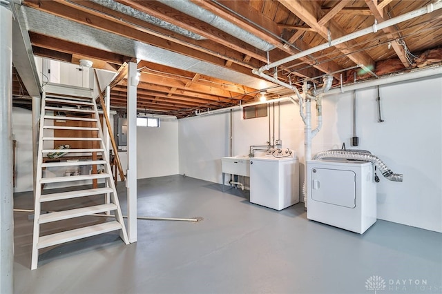 basement with stairs, a sink, and independent washer and dryer