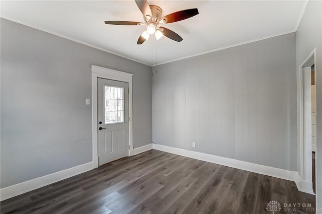 interior space featuring crown molding, dark wood-style flooring, ceiling fan, and baseboards