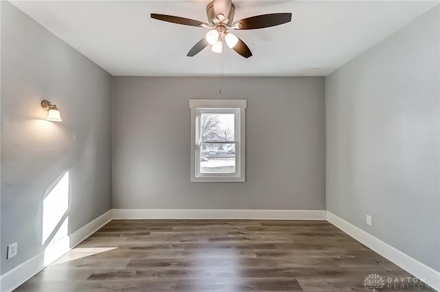 unfurnished room with a ceiling fan, baseboards, and wood finished floors