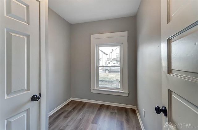 entryway with baseboards and wood finished floors