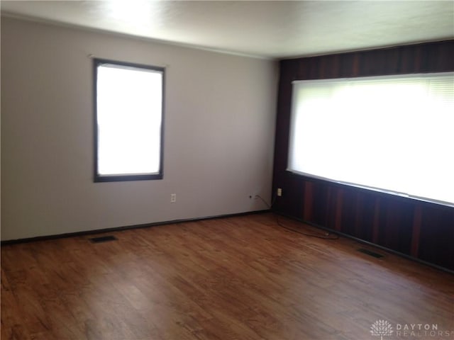 spare room with visible vents and wood finished floors