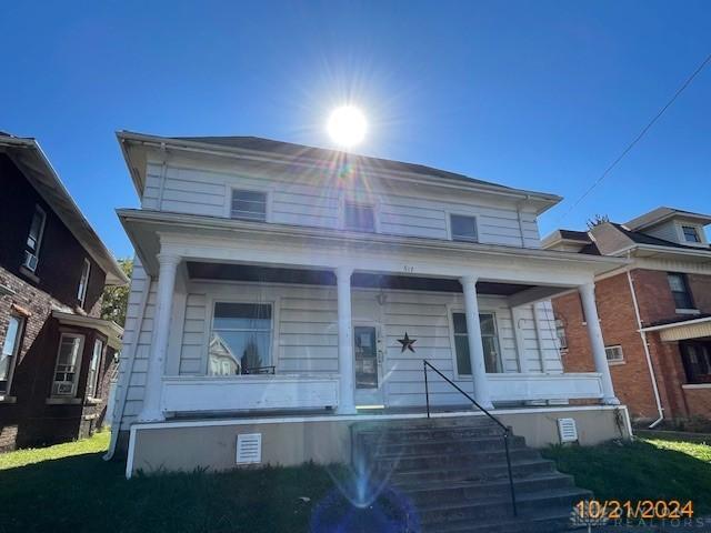 view of front of home with covered porch and crawl space