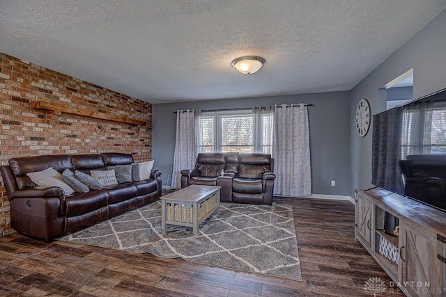 living area featuring dark wood-style floors, baseboards, and a textured ceiling