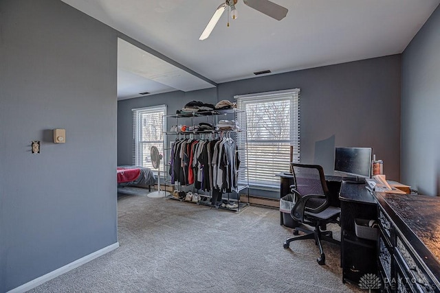 office with carpet floors, visible vents, ceiling fan, and baseboards