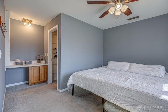 bedroom with baseboards, visible vents, ceiling fan, and light colored carpet