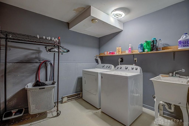 washroom featuring laundry area, a sink, and separate washer and dryer