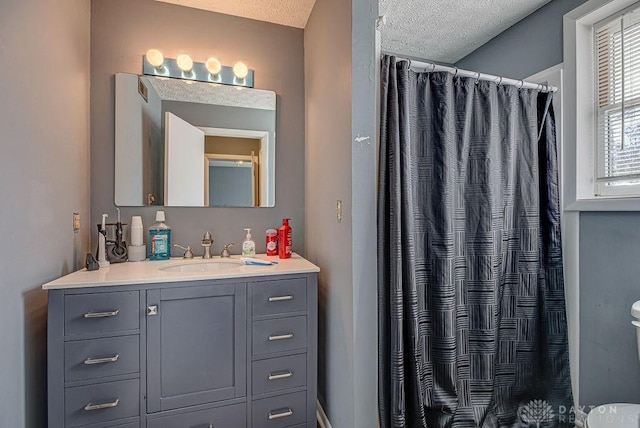 full bath featuring a textured ceiling, a shower with shower curtain, and vanity