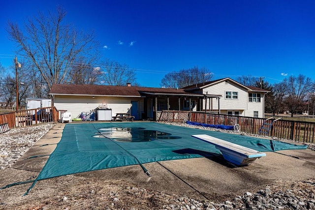 back of property featuring a fenced in pool, a patio area, and fence