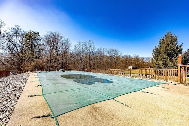 view of pool featuring fence