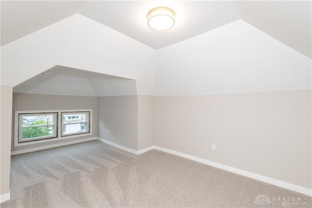 bonus room with lofted ceiling, carpet, and baseboards