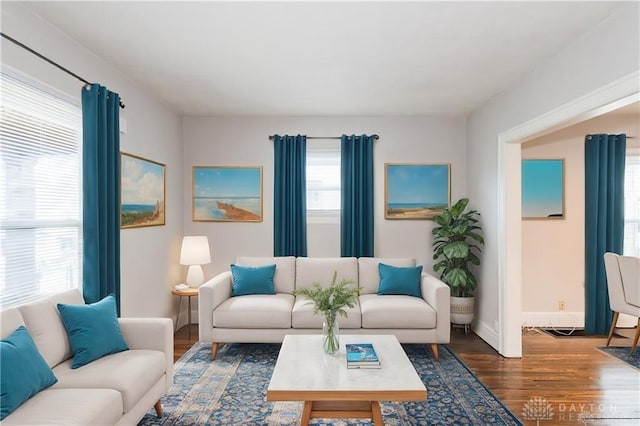 living area with wood finished floors and baseboards