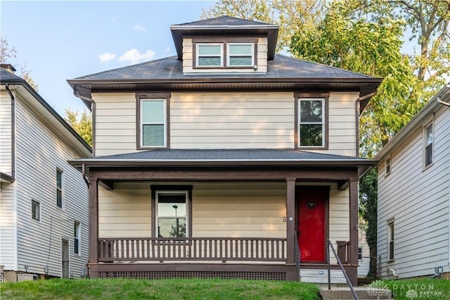 american foursquare style home featuring a porch