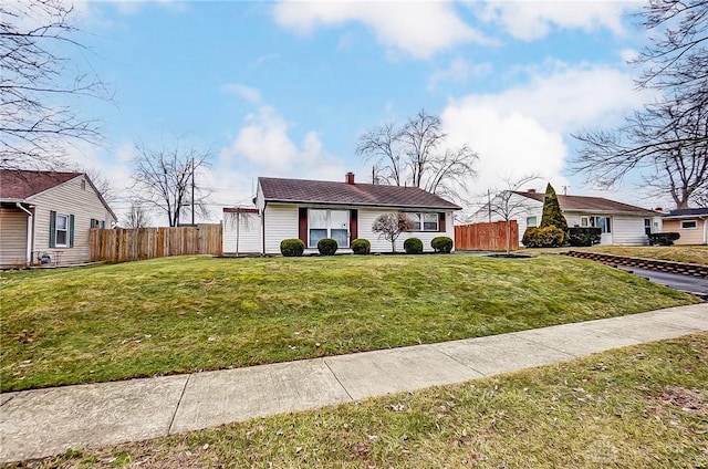 view of front facade with a front yard and fence