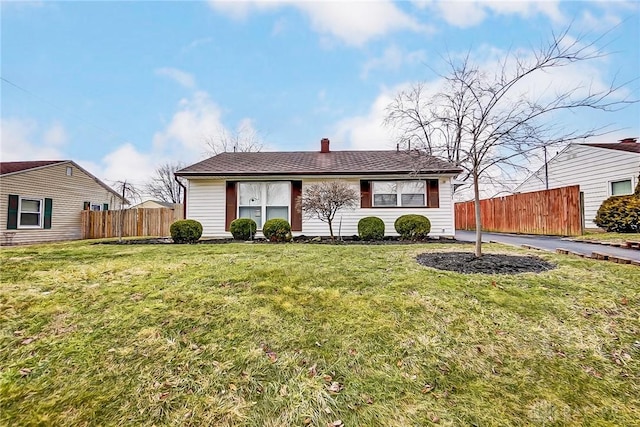 view of front of home featuring a front yard and fence