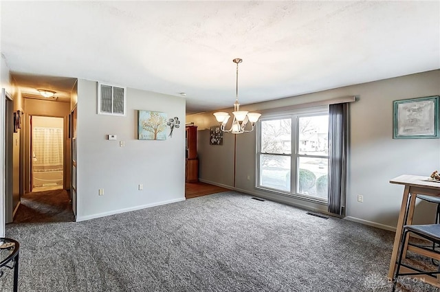 carpeted dining area with an inviting chandelier, visible vents, and baseboards