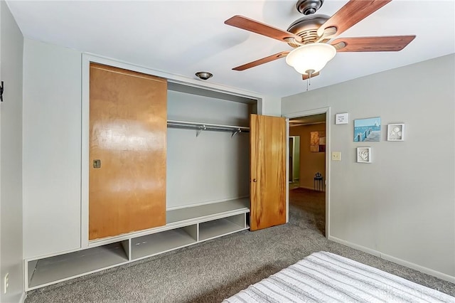 unfurnished bedroom with carpet floors, a closet, a ceiling fan, and baseboards