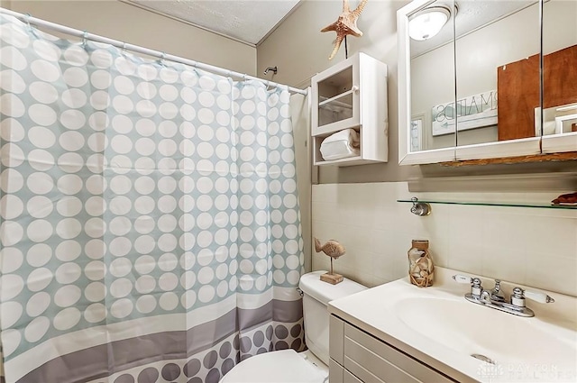 bathroom featuring a shower with curtain, tile walls, toilet, and vanity