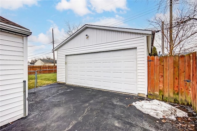 detached garage featuring fence